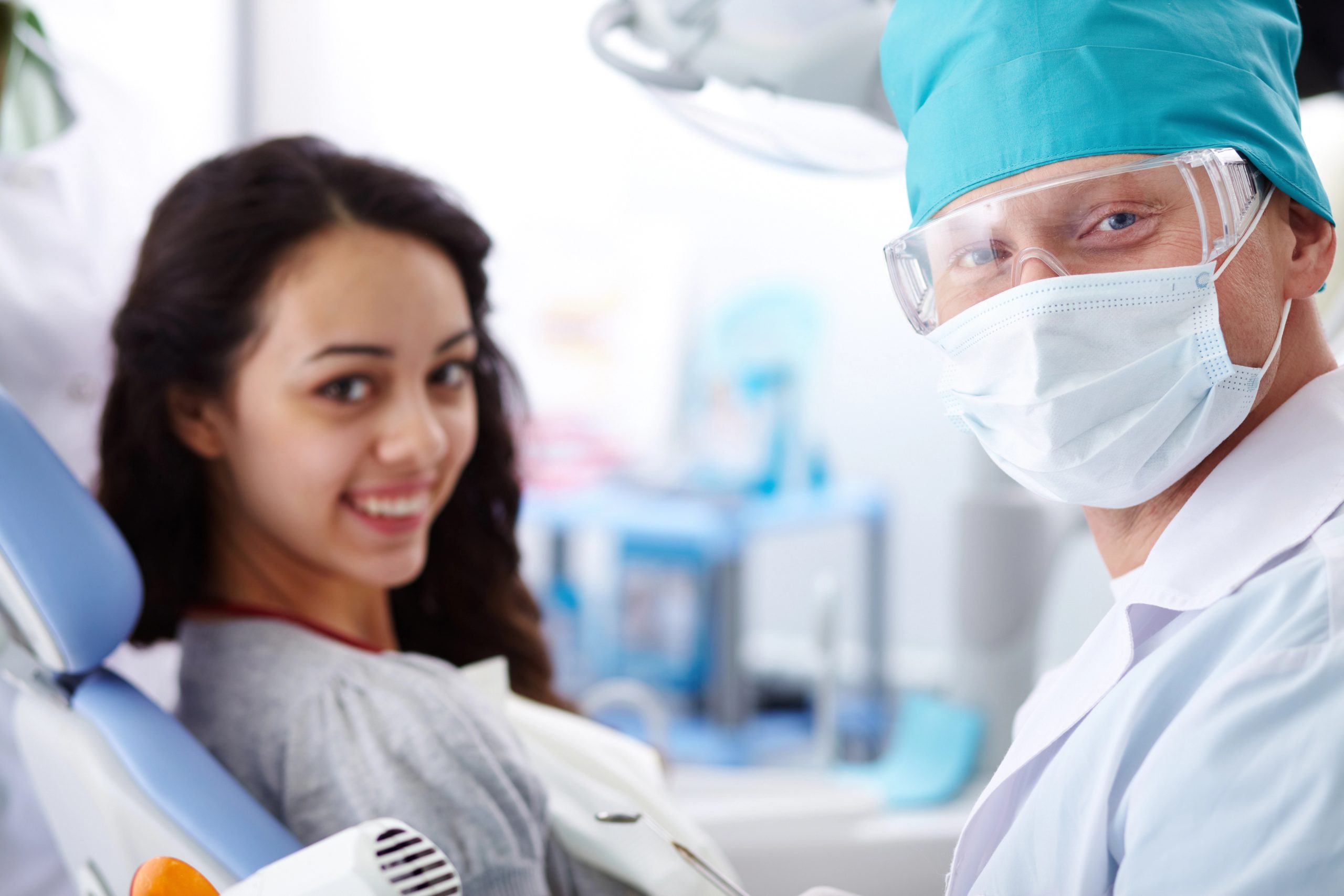 Male dentist and a female patient in a dental office